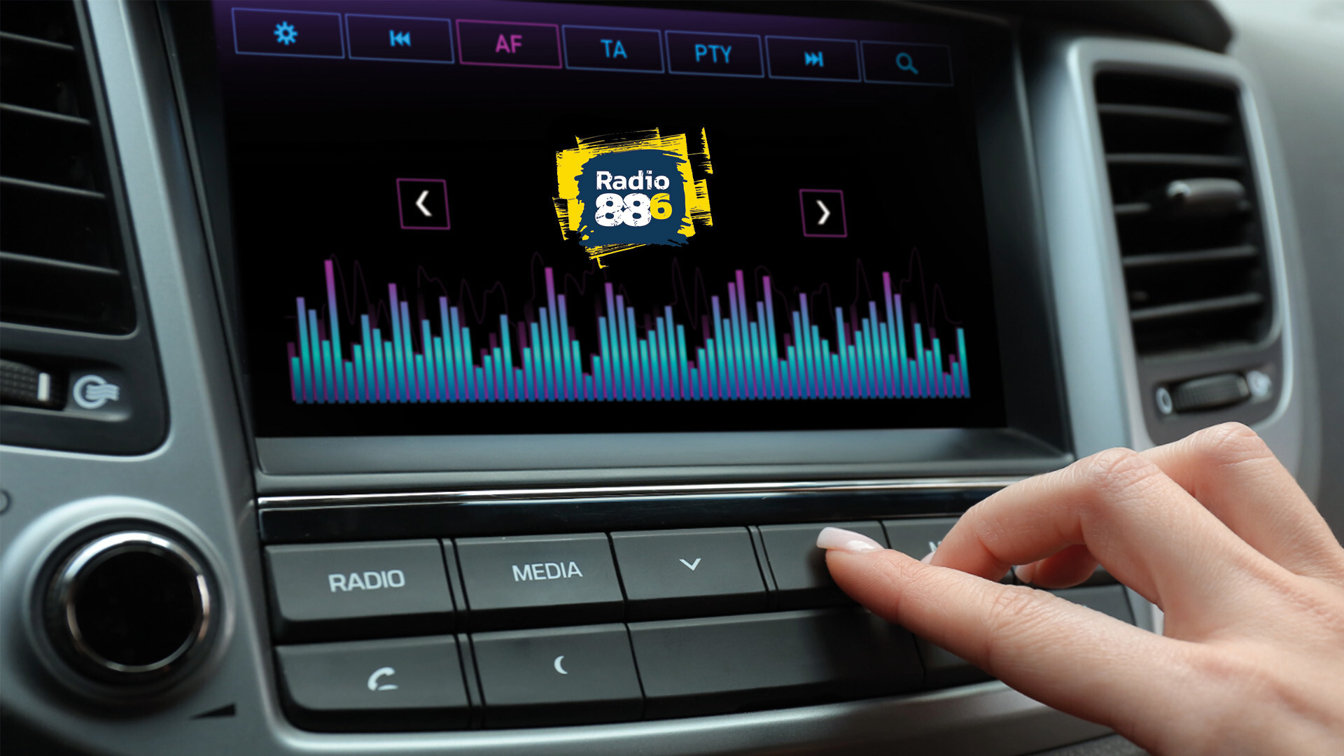 Radio 88.6 Empfang: UKW Frequenzen, Webstreams, Smartspeaker und DAB+ Eine Hand bedient das Autoradio, auf dem Display ist das Radio 88.6 Logo mit Equalizer-Grafik zu sehen